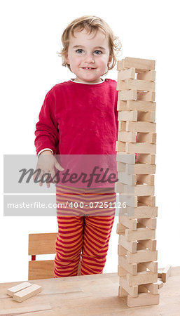 child with tower made of  toy blocks. studio shot isolated on white background