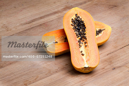 ripe fresh papaya half cut on wooden plate