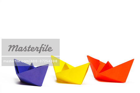 Three colored paper ship on a white background