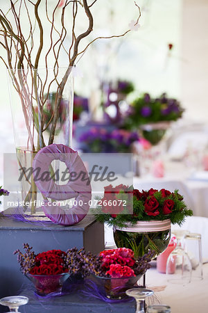 Wedding banquet table with table number, decor and flowers