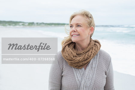 Contemplative casual senior woman looking away at the beach