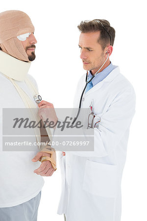 Side view of a doctor auscultating a patient tied up in bandage with stethoscope over  white background