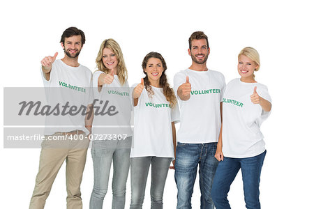 Group portrait of happy volunteers gesturing thumbs up over white background