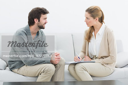 Side view of a young man in meeting with a financial adviser at home