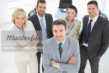 Portrait of a confident business team standing in a bright office