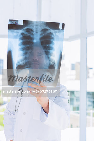 Closeup of a male doctor examining x-ray in the medical office