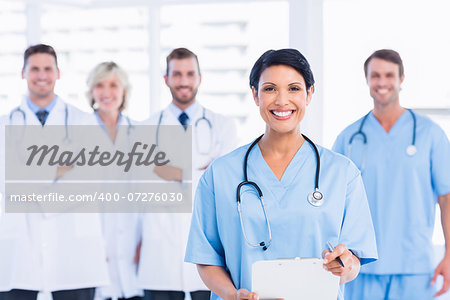 Portrait of confident happy group of doctors standing at the medical office