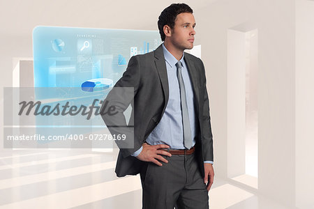 Businessman with hand on hip against steps leading to light in the darkness