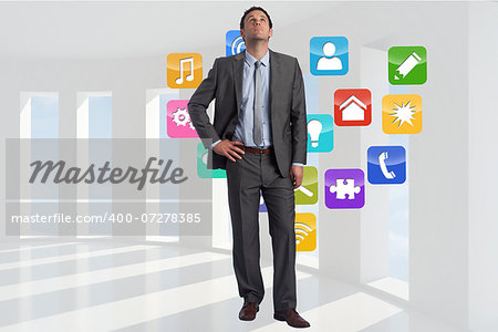 Serious businessman with hand on hip against abstract blue and purple line design