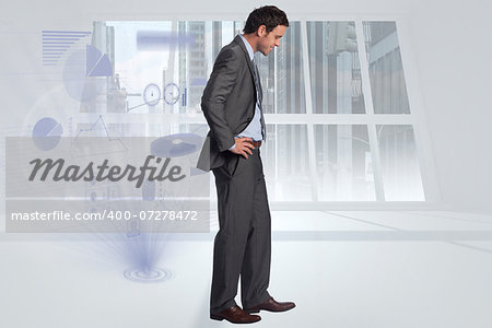 Smiling businessman with hands on hips against steps leading to light in the darkness
