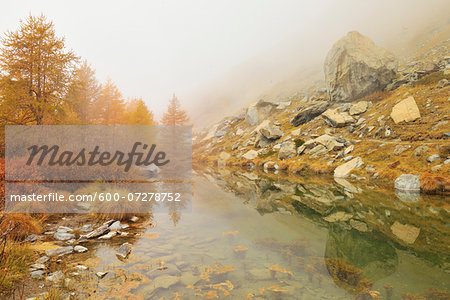 Mountain Lake with Fog in Autumn, Grindjesee, Findeln, Zermatt, Alps, Valais, Switzerland Mountain Lake with Fog in Autumn, Grindjesee, Findeln, Zermatt, Alps, Valais, Switzerland