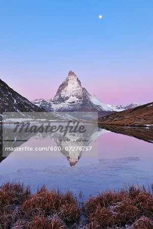 Matterhorn reflected in Lake Riffelsee at Dawn with Moon, Zermatt, Alps, Valais, Switzerland