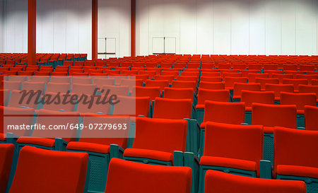 Red chairs in empty auditorium