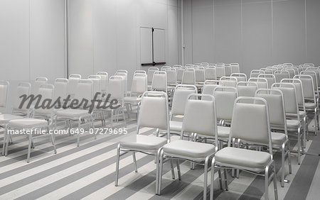 White chairs in empty auditorium White chairs in empty auditorium