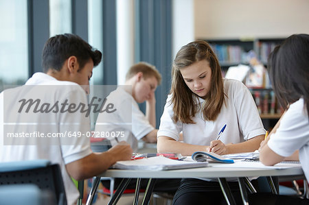 Group of teenagers working in school class