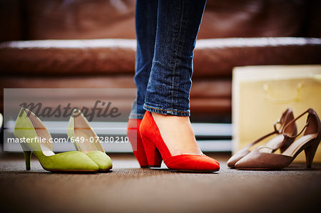 Woman trying on high heeled shoes