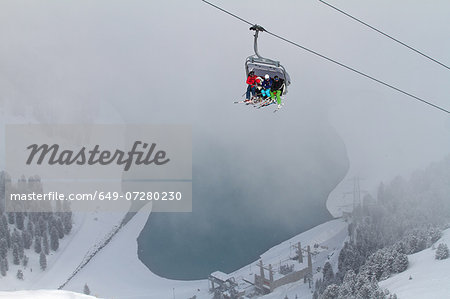 Three people on ski lift in Kuhtai, Austria
