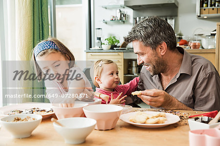 Father and children baking in kitchen