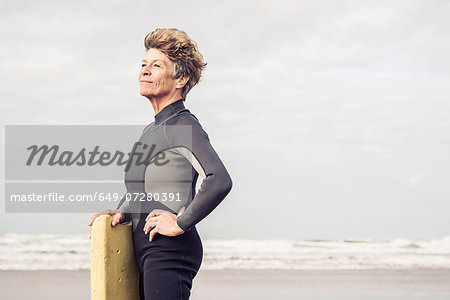 Portrait of mature female bodyboarder, Devon, UK