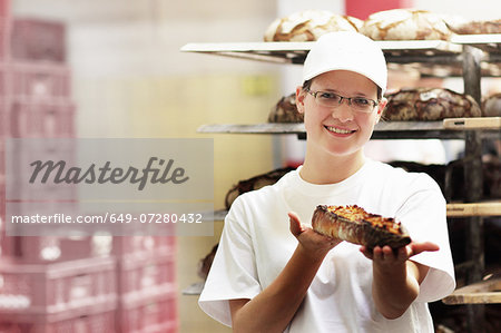 Baker holding fresh bread