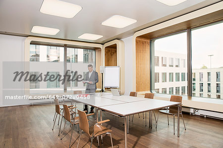 Businessman standing in conference room