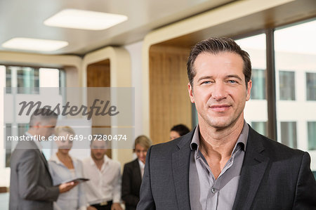 Businessman standing in front of colleagues