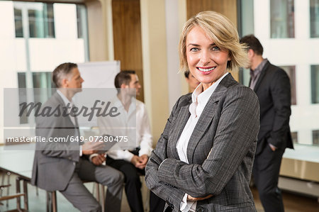 Businesswoman standing in front of colleagues