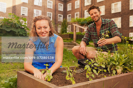 Couple planting vegetables on council estate allotment