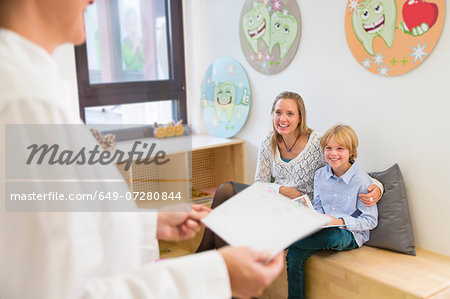Mother and son in dentists waiting room