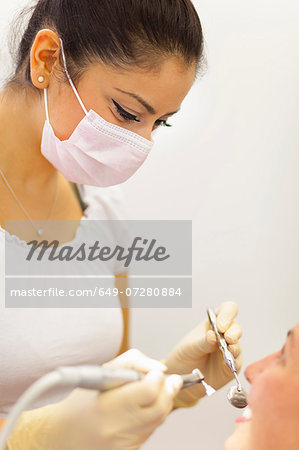 Female dentist working on patient