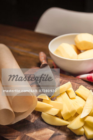 Still life of peeled and sliced potatoes and kitchen knife