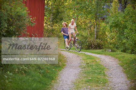 Young adult couple having fun on bicycle, Gavle, Sweden