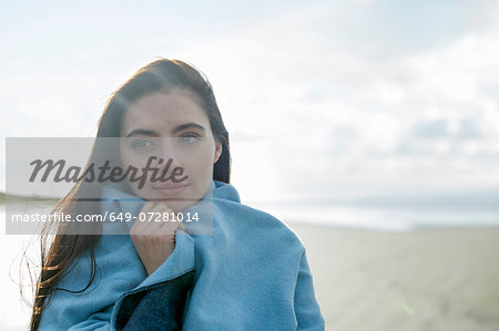 Young woman wrapped in blanket