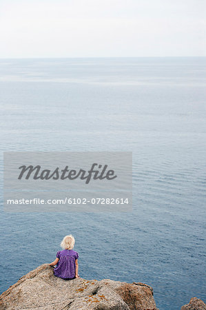 Girl sitting at water, Corsica