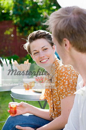 Woman and man talking at garden party