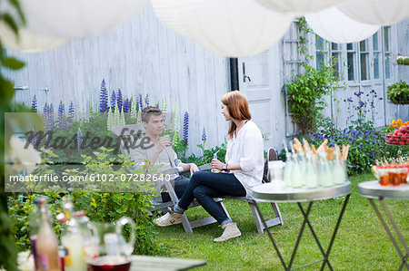 Woman and man talking at garden party