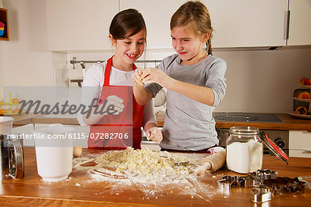 Two girls making Christmas cookies, Munich, Bavaria, Germany