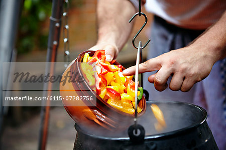 Person Adding Vegetable In Cooking Pot