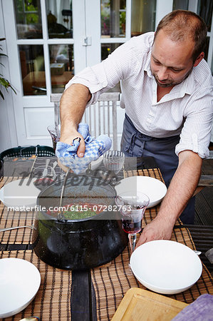 Man Is Stirring Food In Cooking Pot