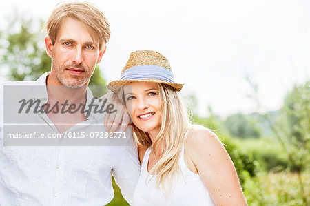 Happy young couple, woman with straw hat, Bavaria, Germany