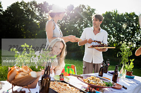 Friends barbecuing on the riverside, foothills of the Alps, Bavaria, Germany