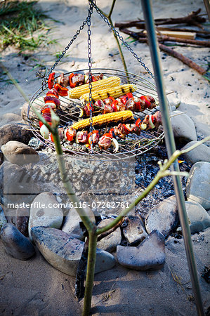 Barbecue on the riverside, meat skewers and corn on the cob, Bavaria, Germany