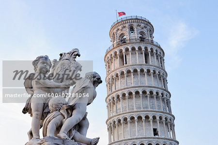 Cherub Statue of Fontana Dei Putti with Leaning Tower of Pisa, Piazza dei Miracoli, Pisa, Tuscany, Italy