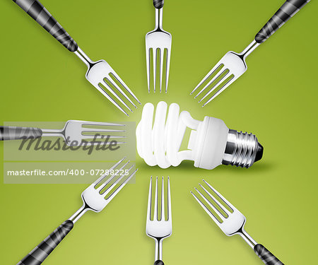 Forks around light bulb, on green background