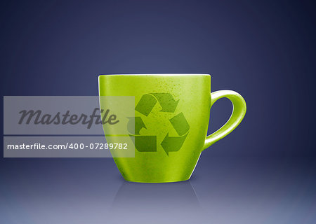 Green tea mug or cup with recycle sign on it, environmental conceptual image.