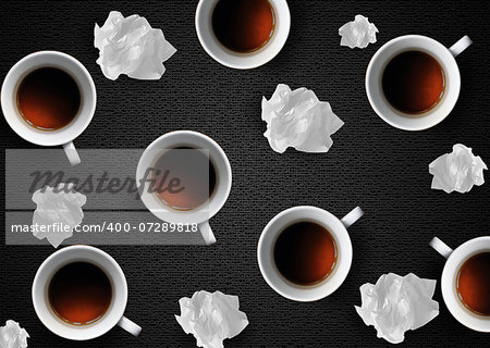 Crumpled colorful papers with coffee on black desktop.