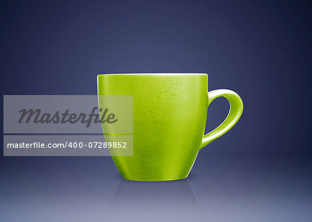 Green tea mug or cup on blue background.