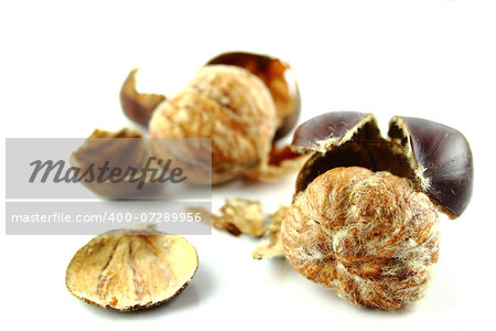 Sweet chestnuts with peels on white background.