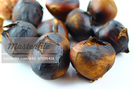 roasted sweet chestnuts on white background.