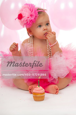 Birthday baby eating her cake